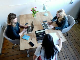 three women sitting and facing each other