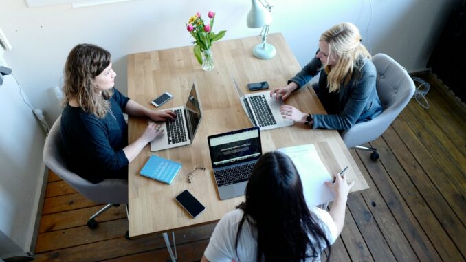 three women sitting and facing each other