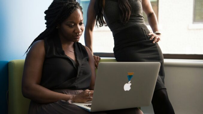 woman sitting infront of MacBook