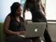 woman sitting infront of MacBook